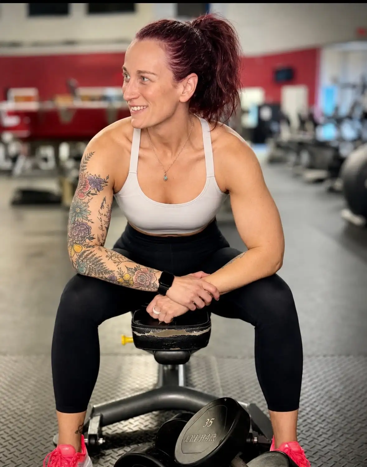 Hillary Meyers, certified personal trainer, sitting on a gym bench